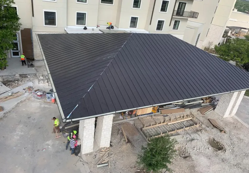 Metal roofing installation team working on a commercial building in Waterford